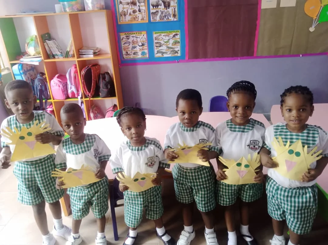 Somdal nursery pupils proudly displaying a creative classroom activity